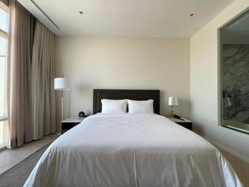 Modern bedroom with double bed and bedside lamps