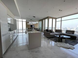 Spacious open-concept living room and kitchen with city view