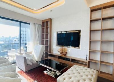 Modern living room with large window and built-in shelves