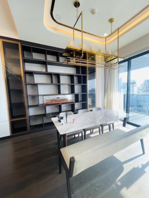 Modern dining room with chic lighting and built-in shelving