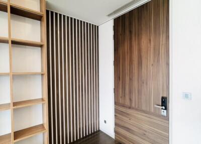 Modern bedroom with wooden door and shelving unit