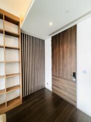 Modern bedroom with wooden door and shelving unit