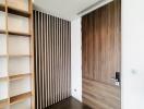 Modern bedroom with wooden door and shelving unit