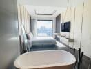 Modern bathroom with freestanding bathtub and glass partition