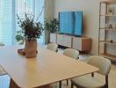 Modern living room with dining table, TV, and shelving