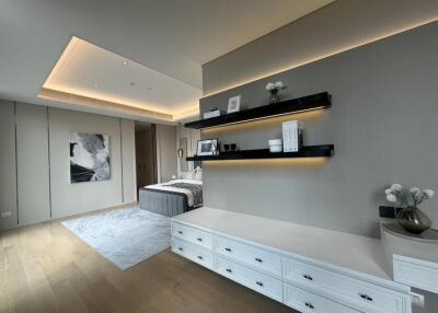 modern bedroom with recessed lighting and built-in shelves