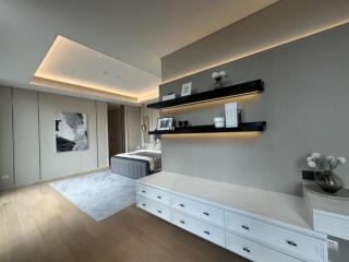 modern bedroom with recessed lighting and built-in shelves