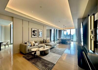 Modern living room with a large sofa, coffee tables and dining area