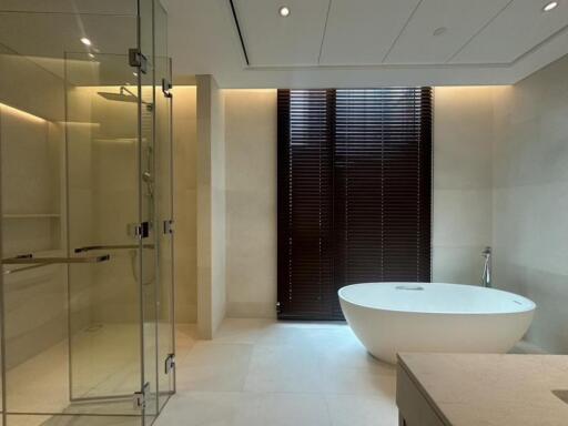 Modern bathroom with glass shower and freestanding bathtub