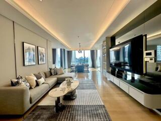 Spacious living room with modern decor and large TV