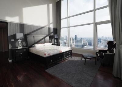 Spacious bedroom with large windows and city view