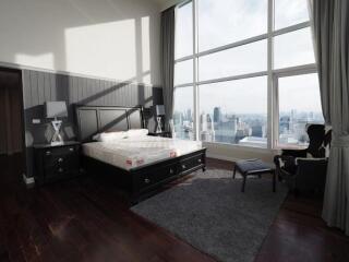 Spacious bedroom with large windows and city view