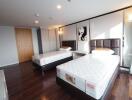 Two-bed bedroom with modern decor and wooden flooring