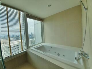 Modern bathroom with large bathtub and city view