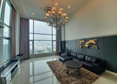 Spacious living room with large windows and city views