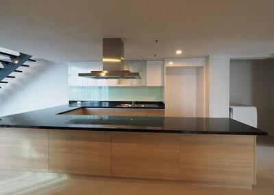 Modern kitchen with island and staircase