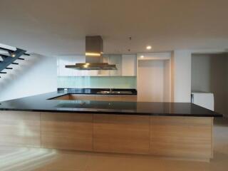 Modern kitchen with island and staircase