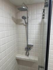 shower area with white tiled walls