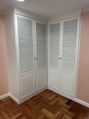 Closet with louvered doors in a bedroom