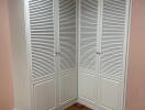 Closet with louvered doors in a bedroom