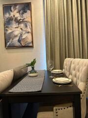 Elegant dining area with artwork and table setting