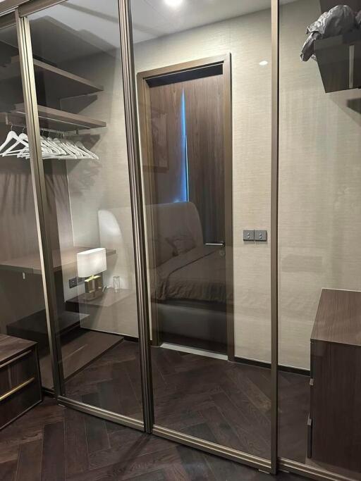 Walk-in closet with glass doors and wooden interior