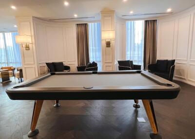 Elegant living space with a pool table and seating area