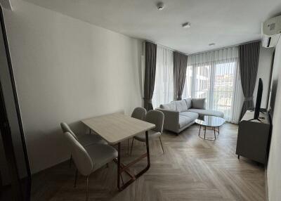 Modern living room with dining area and large window