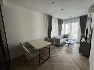 Modern living room with dining area and large window