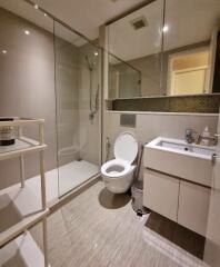 Modern bathroom with glass shower and vanity.