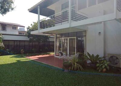 Modern two-story house with patio and garden