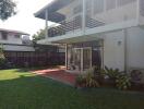 Modern two-story house with patio and garden