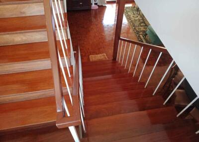 Wooden staircase with white railings