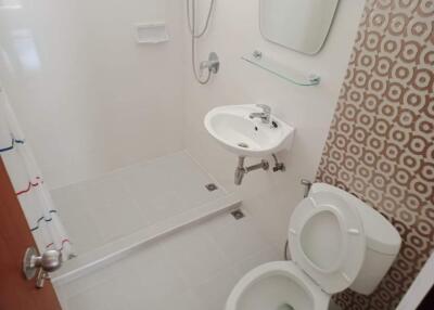 Bathroom with shower, sink, and toilet