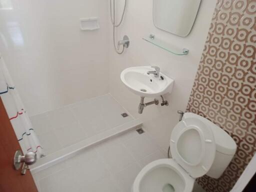 Bathroom with shower, sink, and toilet