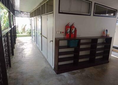 Hallway with fire extinguishers and storage shelves