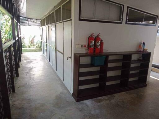 Hallway with fire extinguishers and storage shelves