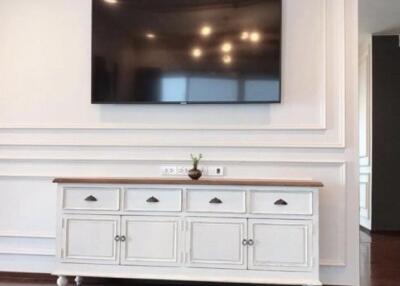 Living room with wall-mounted TV and white cabinet