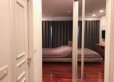 Bedroom with wooden floor and mirrored wardrobe