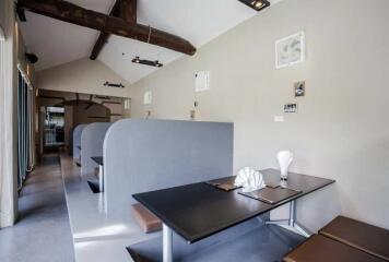 Contemporary dining area with built-in booths and wooden beams