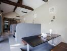 Contemporary dining area with built-in booths and wooden beams