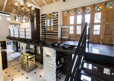 Two-level loft with wooden staircase and decorative glass windows