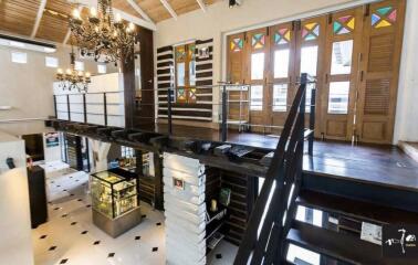 Two-level loft with wooden staircase and decorative glass windows