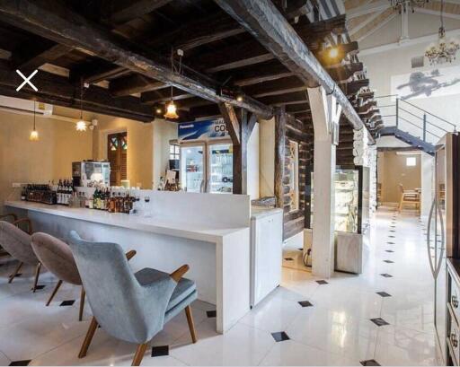 Interior view of a contemporary designed space with bar seating, modern furniture, and an industrial feel.