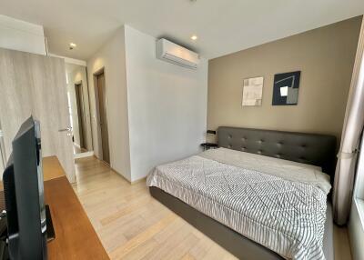 Modern bedroom with a large bed and a wall-mounted air-conditioning unit