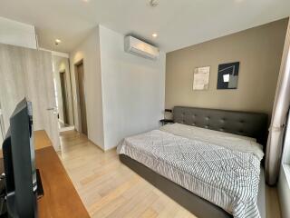 Modern bedroom with a large bed and a wall-mounted air-conditioning unit