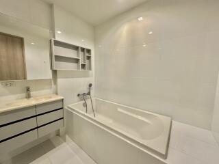 Modern white bathroom with bathtub and sink