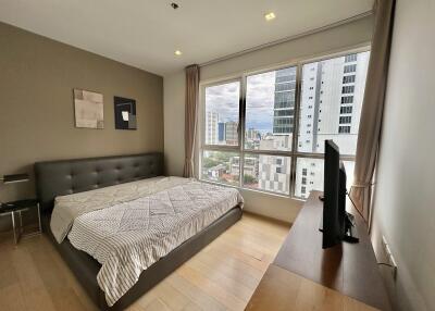 Modern bedroom with large window and city view