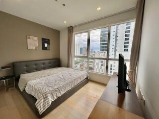 Modern bedroom with large window and city view