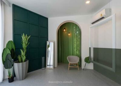 Modern interior space with green accent wall and archway